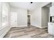 Living room with light walls and ceiling, gray flooring, and entry to kitchen at 330 Central Ave, Kannapolis, NC 28081
