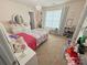 Bright bedroom featuring a floral bedspread, chandelier, and ample storage with shelves and drawers at 3416 Yarmouth Ln, Gastonia, NC 28056