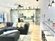 Open-concept living room featuring a large gray sofa, a daybed, and rustic sliding barn doors at 3416 Yarmouth Ln, Gastonia, NC 28056