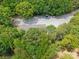 Aerial view of a long stone driveway with two parked cars leading to a home surrounded by mature trees at 364 Luther Dr, Iron Station, NC 28080