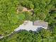Aerial view of home with huge detached garage surrounded by lush trees at 364 Luther Dr, Iron Station, NC 28080