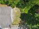 Aerial view of a gray home with a shingled roof and fenced in back yard bordering a mature tree line at 364 Luther Dr, Iron Station, NC 28080