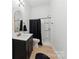 Updated bathroom with modern vanity, decorative mirror, and step-in shower at 364 Luther Dr, Iron Station, NC 28080