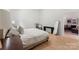 Minimalist bedroom with light wood floors, a cozy bed, and a view of the other side of the house at 364 Luther Dr, Iron Station, NC 28080