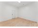 Bright bedroom features wood floors, neutral paint, and a door at 364 Luther Dr, Iron Station, NC 28080