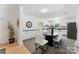 Bright dining room features ample cabinetry, adjacent to a renovated kitchen with stainless appliances at 364 Luther Dr, Iron Station, NC 28080
