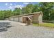 Three-car garage boasts ample parking space and an inviting covered porch with a decorative American flag at 364 Luther Dr, Iron Station, NC 28080
