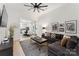 Inviting living room with view to a modern white kitchen and a large comfortable sectional sofa at 364 Luther Dr, Iron Station, NC 28080