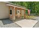 Inviting covered porch featuring a charming American flag and decorative wreath, leading to a well-maintained entrance at 364 Luther Dr, Iron Station, NC 28080