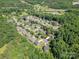 Aerial view of a neighborhood in a verdant, wooded area with homes and lush treescape at 3917 Erskine Woods Dr, Bessemer City, NC 28016