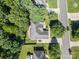 Aerial view of a home with a driveway and an oversized yard with mature trees throughout the landscape at 3917 Erskine Woods Dr, Bessemer City, NC 28016