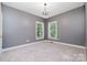 Bedroom featuring plush carpeting, neutral gray walls, and a contemporary chandelier at 3917 Erskine Woods Dr, Bessemer City, NC 28016