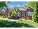 Charming brick home features a well-manicured lawn and a traditional design with black shutters at 3917 Erskine Woods Dr, Bessemer City, NC 28016