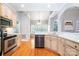 Bright eat-in kitchen features stainless steel appliances, cream cabinets, and gorgeous hardwood floors at 3917 Erskine Woods Dr, Bessemer City, NC 28016