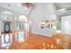 Open-concept living area with hardwood floors, arched openings, and views into the kitchen at 3917 Erskine Woods Dr, Bessemer City, NC 28016