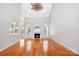 Bright living room with a fireplace, hardwood floors, and neutral paint, with kitchen views at 3917 Erskine Woods Dr, Bessemer City, NC 28016