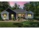Charming home with a combination of modern black and white facade with professionally landscaped front yard at 402 Wildlife Rd, Troutman, NC 28166