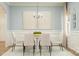 Elegant dining room with a modern chandelier, large windows, and stylish decor, perfect for gatherings at 4247 Skyboat Cir, Fort Mill, SC 29715
