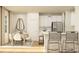Bright kitchen featuring white cabinets, stainless steel appliances, breakfast bar, and adjacent dining area at 4247 Skyboat Cir, Fort Mill, SC 29715