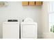 Functional laundry room equipped with a modern washing machine and dryer, topped with fresh, white towels at 4247 Skyboat Cir, Fort Mill, SC 29715