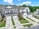Aerial view of townhomes with garages, driveways, and manicured landscaping at 45008 Wigeon Ln # 202, Indian Land, SC 29707
