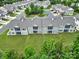 Aerial view of townhomes with large backyards and green spaces, bordered by mature trees at 45008 Wigeon Ln # 202, Indian Land, SC 29707