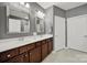 Primary bathroom with a double sink vanity, large mirror, and decorative lighting fixtures at 45008 Wigeon Ln # 202, Indian Land, SC 29707