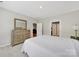 This bedroom features a dresser and connects to the rest of the home through doorways at 45008 Wigeon Ln # 202, Indian Land, SC 29707