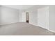 This bedroom has neutral carpet, white trim, and multiple doors leading into other rooms at 45008 Wigeon Ln # 202, Indian Land, SC 29707
