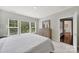 Bright primary bedroom with large windows and a wood dresser for storage and organization at 45008 Wigeon Ln # 202, Indian Land, SC 29707