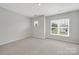 This bedroom has neutral carpet and lots of natural light from its bright, large windows at 45008 Wigeon Ln # 202, Indian Land, SC 29707