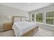 This bedroom is bright with large windows and has matching nightstands and lamps at 45008 Wigeon Ln # 202, Indian Land, SC 29707