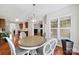 Dining room with wood floors, four chairs, window, and decorative light fixture at 45008 Wigeon Ln # 202, Indian Land, SC 29707