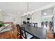 Open-concept dining room featuring hardwood floors, a chandelier, and views of the living room at 45008 Wigeon Ln # 202, Indian Land, SC 29707