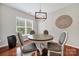 Dining room with a round table, four chairs, wood floors, and a decorative wall hanging at 45008 Wigeon Ln # 202, Indian Land, SC 29707