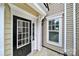 Inviting front entrance with a black door, white trim and large window providing natural light into the foyer at 45008 Wigeon Ln # 202, Indian Land, SC 29707