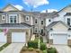 Charming townhome featuring a brick facade, attached garage, and manicured landscaping at 45008 Wigeon Ln # 202, Indian Land, SC 29707