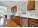 Kitchen with stainless steel appliances, white countertops, wood cabinets, and hardwood floors at 45008 Wigeon Ln # 202, Indian Land, SC 29707