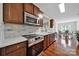 Kitchen with stainless steel appliances, white countertops, wood cabinets, and hardwood floors at 45008 Wigeon Ln # 202, Indian Land, SC 29707