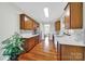 Kitchen with stainless steel appliances, wood cabinets, white countertops, and hardwood floors at 45008 Wigeon Ln # 202, Indian Land, SC 29707