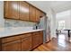 Kitchen with stainless steel appliances, wood cabinets, white countertops, and hardwood floors at 45008 Wigeon Ln # 202, Indian Land, SC 29707