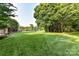 Expansive backyard with lush green grass, mature trees, and a private fenced boundary at 4637 Shannamara Dr, Matthews, NC 28104