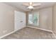 Neutral bedroom featuring plush carpeting, a window with blinds, and a ceiling fan at 4637 Shannamara Dr, Matthews, NC 28104