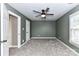 Spacious carpeted bedroom with soothing neutral tones, a ceiling fan, and a window at 4637 Shannamara Dr, Matthews, NC 28104