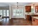 Bright breakfast nook with a window and hardwood floors adjacent to the open-concept kitchen at 4637 Shannamara Dr, Matthews, NC 28104