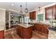Open kitchen with granite island, stainless appliances, and view to living room at 4637 Shannamara Dr, Matthews, NC 28104