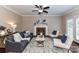 Comfortable living room with a brick fireplace, ceiling fan, and stylish decor at 4637 Shannamara Dr, Matthews, NC 28104