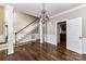 Open-concept living area with hardwood floors, staircase, and access to the kitchen at 4637 Shannamara Dr, Matthews, NC 28104