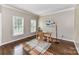 Cozy office with hardwood floors, two windows, neutral walls, and modern decor at 4637 Shannamara Dr, Matthews, NC 28104