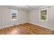 Serene bedroom with hardwood floors and large windows, providing ample light at 5170 Woodleaf Rd, Salisbury, NC 28147